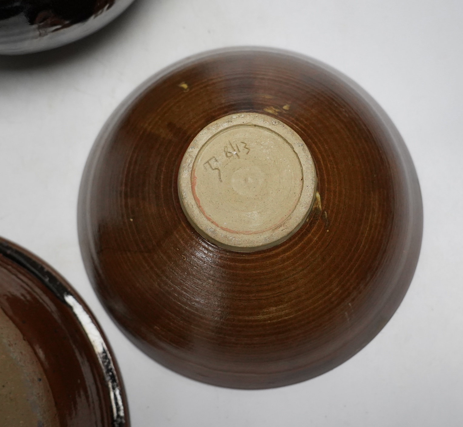A David Melville studio stoneware pot and cover, a large dish and plate, largest 30cm diameter